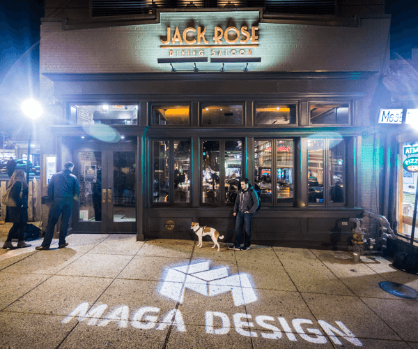 Maga Design logo projected on Adams Morgan sidewalk